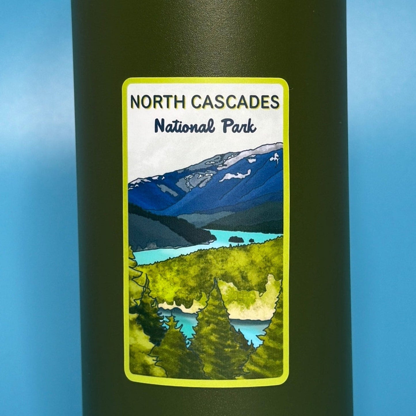 Green YETI water bottle with North Cascades National Park label on a blue background